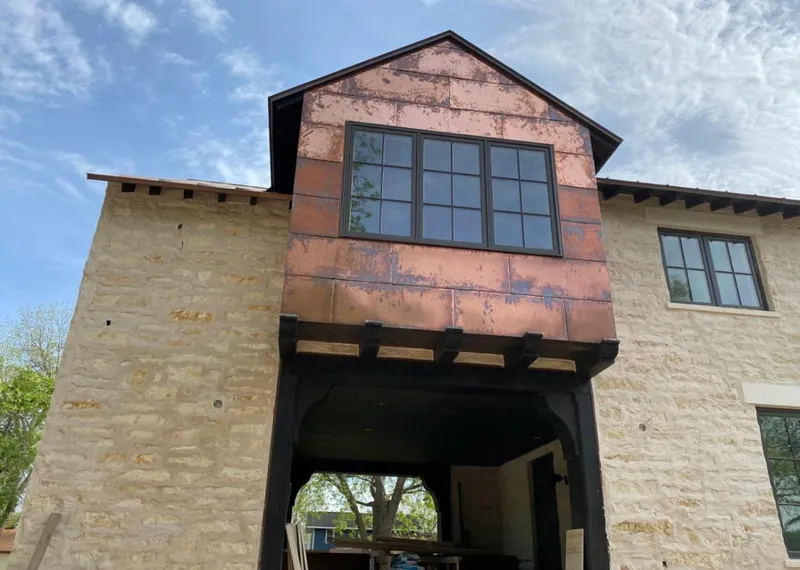 Copper metal panel facade on a stone building for Skylight Installation in Dingman